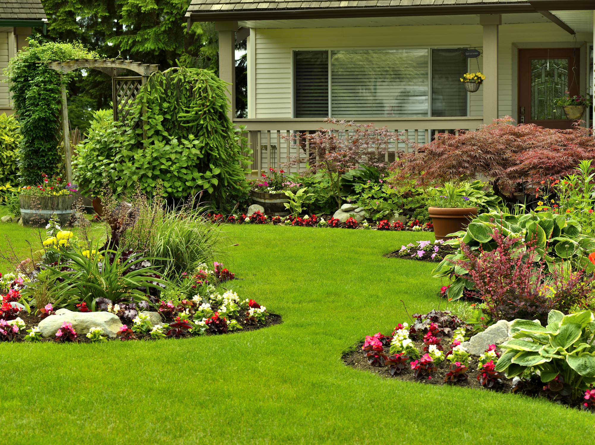 A beautifully arranged flower garden and residential yard.